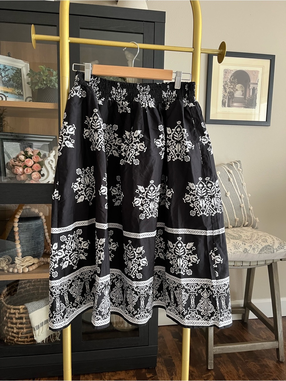 CeCe cotton poplin A-line midi skirt in black with a white botanical print. - Picture 3 of 7